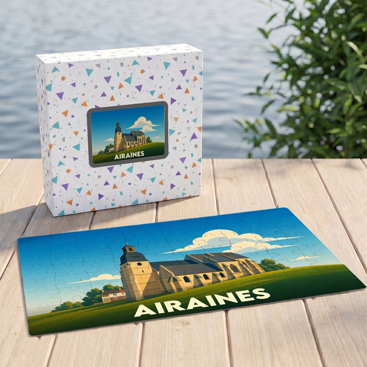 Puzzle souvenir de la ville d'Airaines avec une illustration stylisée d'une église sur fond de paysage.