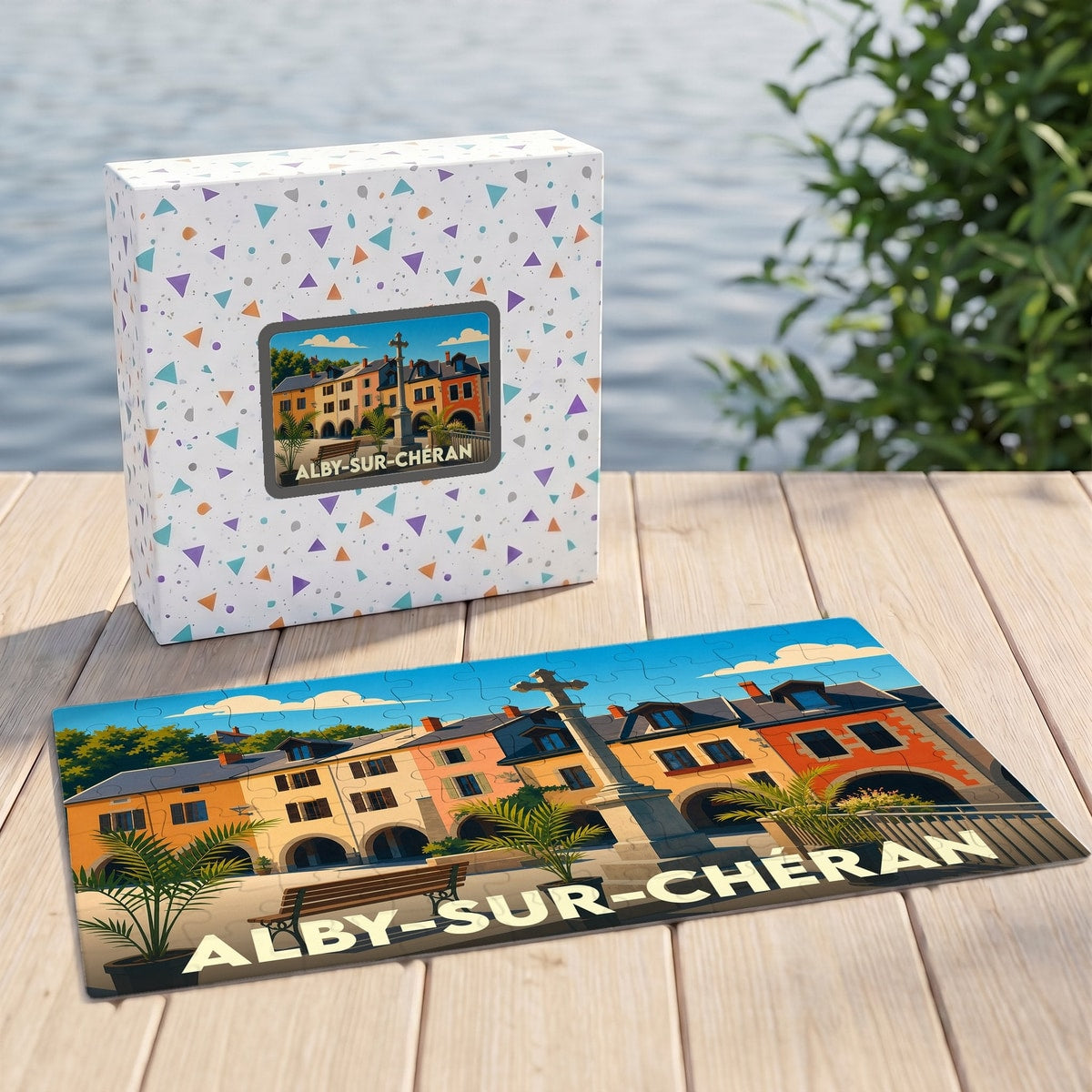 Puzzle souvenir de la ville d'Alby-sur-Chéran avec une illustration colorée et stylisée de ses bâtiments historiques.