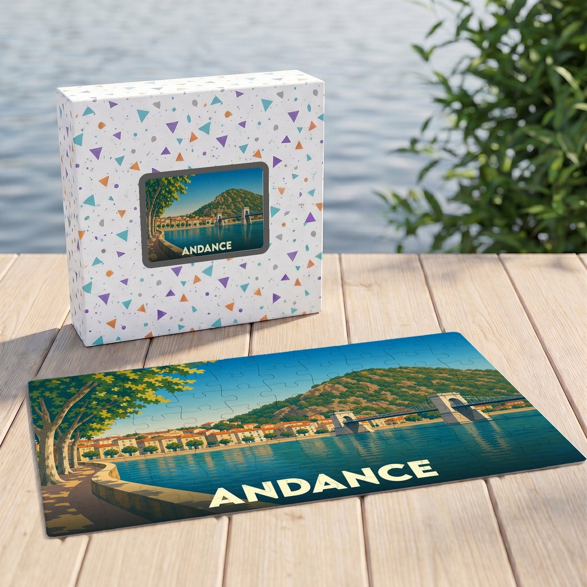 Puzzle souvenir de la ville d'Andance avec une illustration stylisée des bords du Rhône et de son pont.