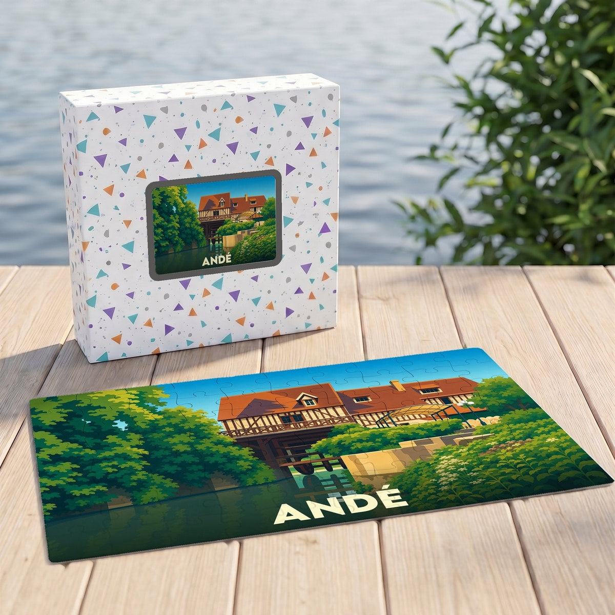 Puzzle souvenir de la ville de Andé avec une illustration stylisée de son moulin sur le bord de l'eau.