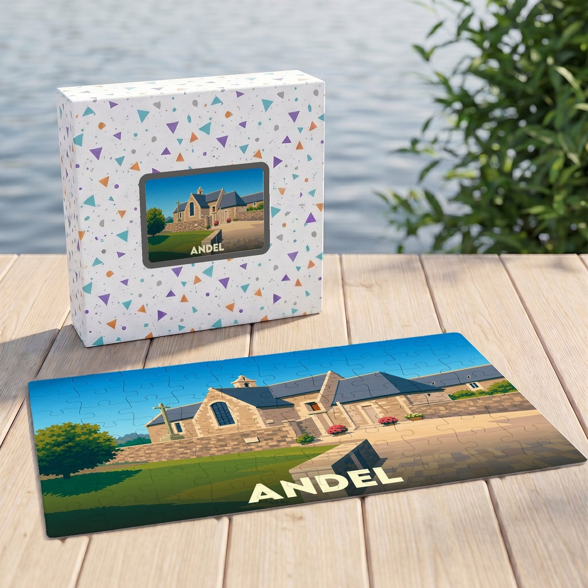 Puzzle souvenir de la ville d'Andel avec une illustration stylisée d'un bâtiment historique et son coffret assorti.
