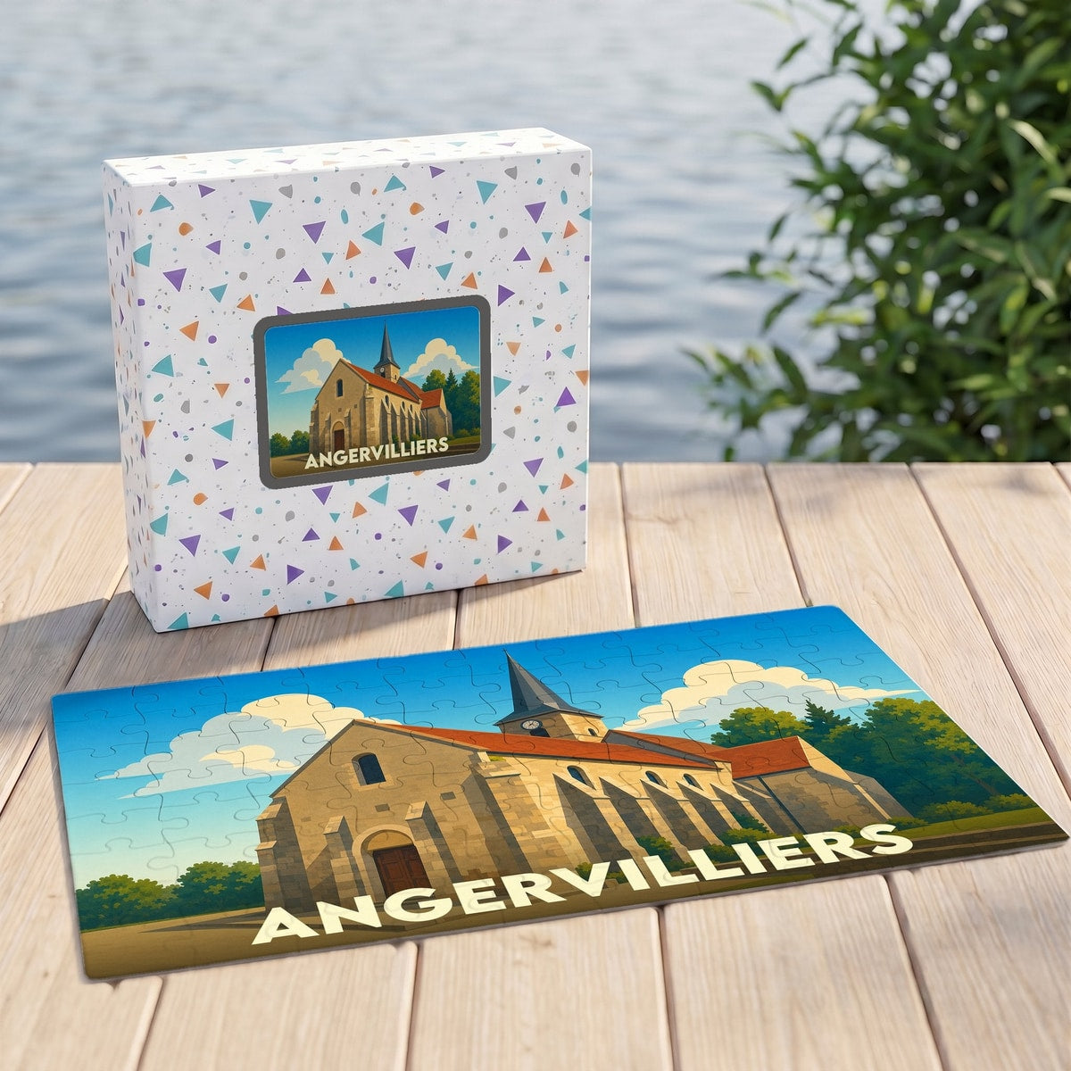 Puzzle souvenir de la ville d'Angervilliers avec une illustration stylisée d'une église sur sa boîte assortie.