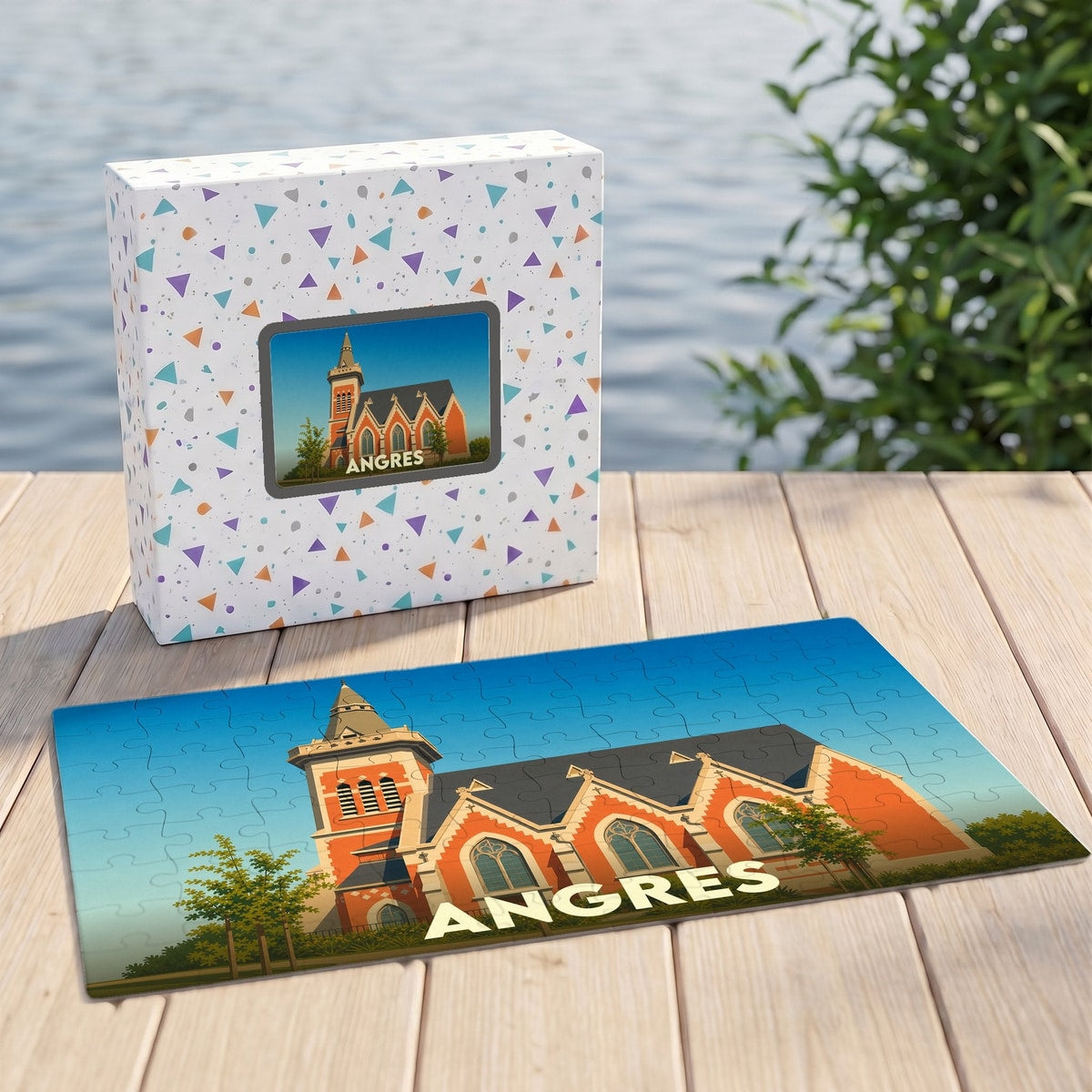 Puzzle souvenir de la ville d'Angres illustré d'un bâtiment historique stylisé, posé à côté de sa boîte.