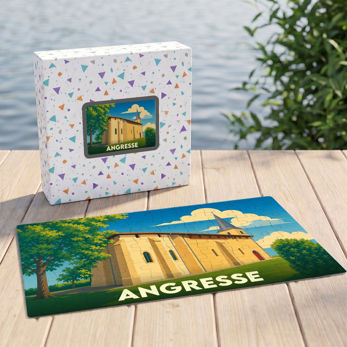 Puzzle souvenir de la ville d'Angresse avec une illustration stylisée d'une église sur sa boîte et ses pièces assemblées.