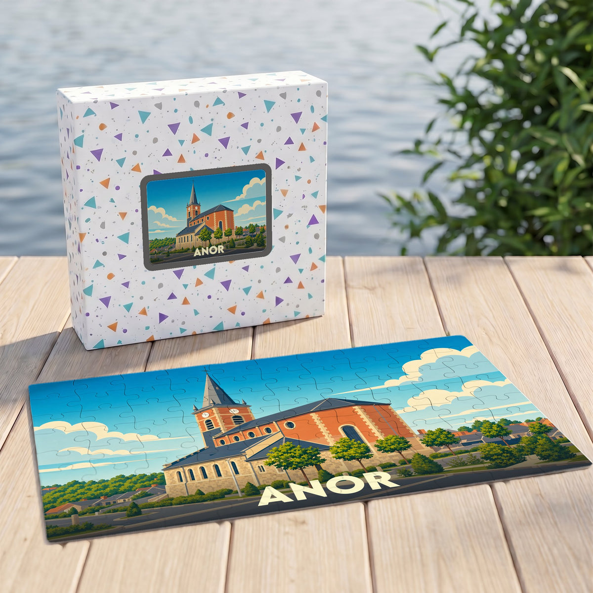 Puzzle souvenir de la ville d'Anor avec une illustration stylisée de son église sur sa boîte et en pièces assemblées.