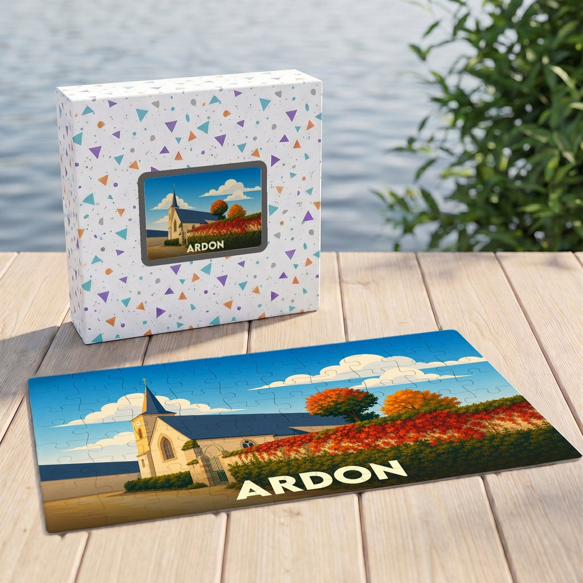 Puzzle souvenir de la ville d'Ardon avec une illustration stylisée représentant son église et des paysages automnaux.