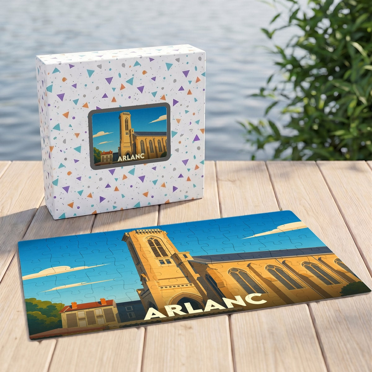 Puzzle souvenir de la ville d'Arlanc illustré par une vue stylisée de son église sous un ciel bleu.