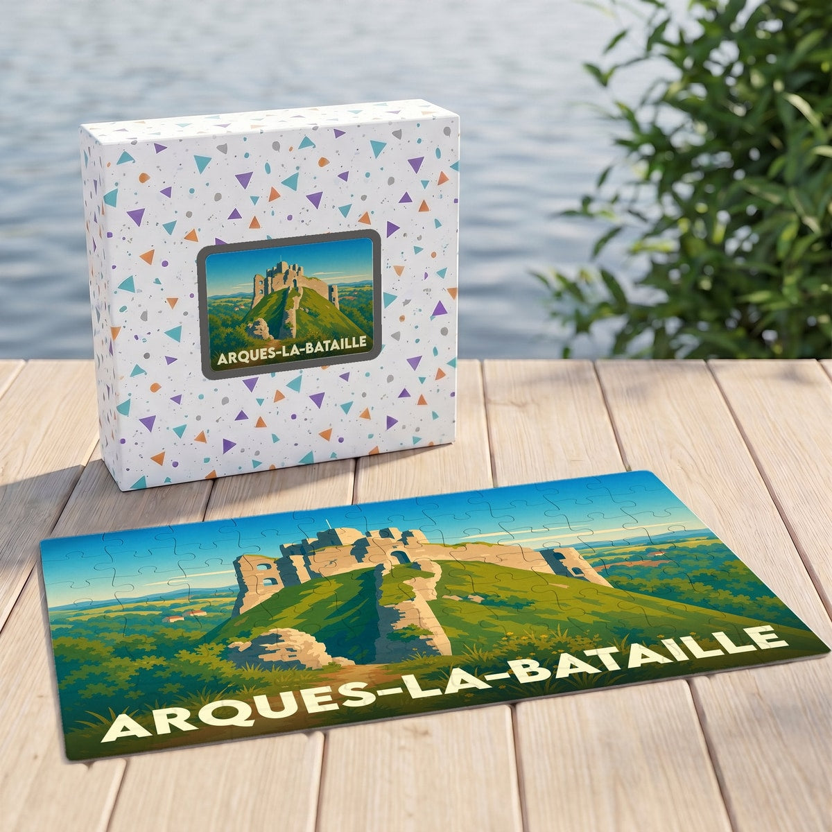 Puzzle souvenir de la ville d'Arques-la-Bataille illustrant les ruines de son château sur une colline verdoyante.