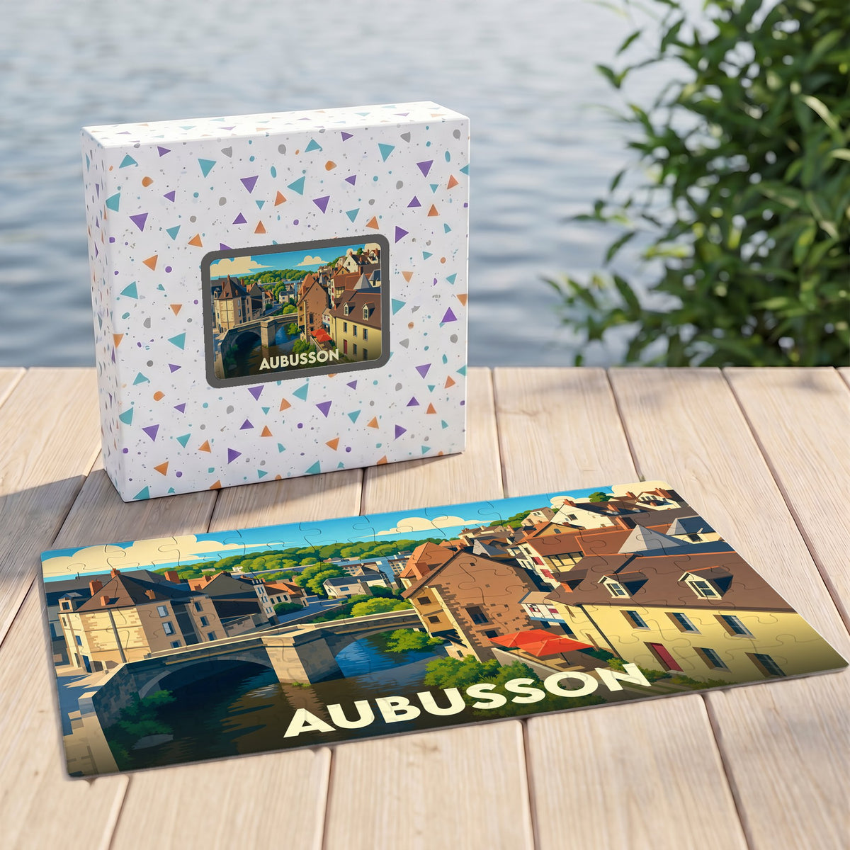 Puzzle souvenir de la ville d'Aubusson avec une illustration stylisée d'un pont et de maisons anciennes.
