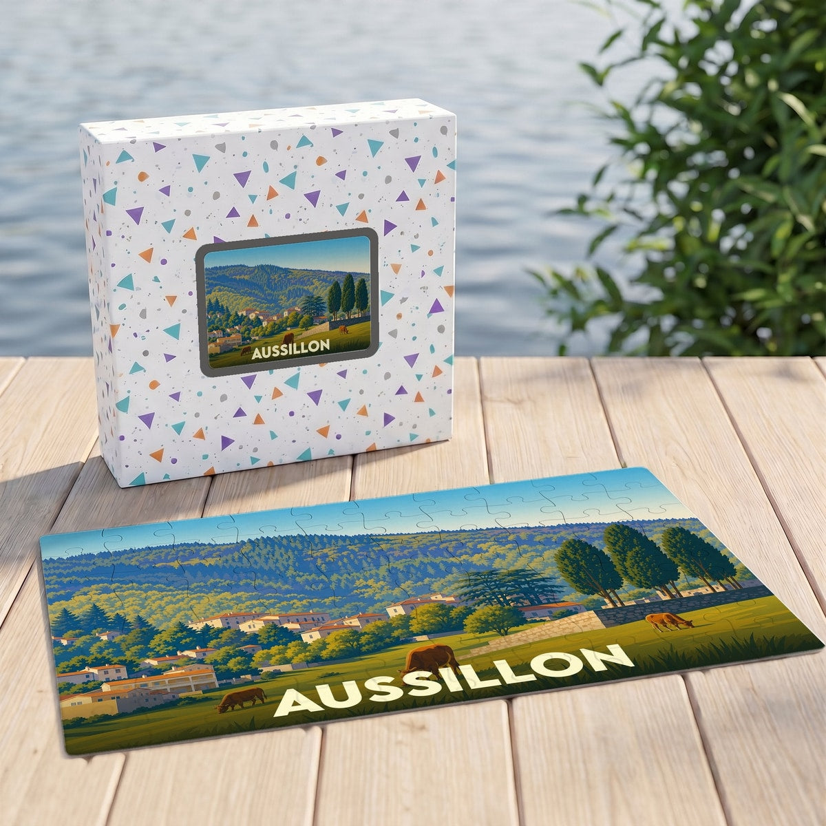 Puzzle souvenir de la ville d'Aussillon avec une illustration stylisée de son paysage vallonné.