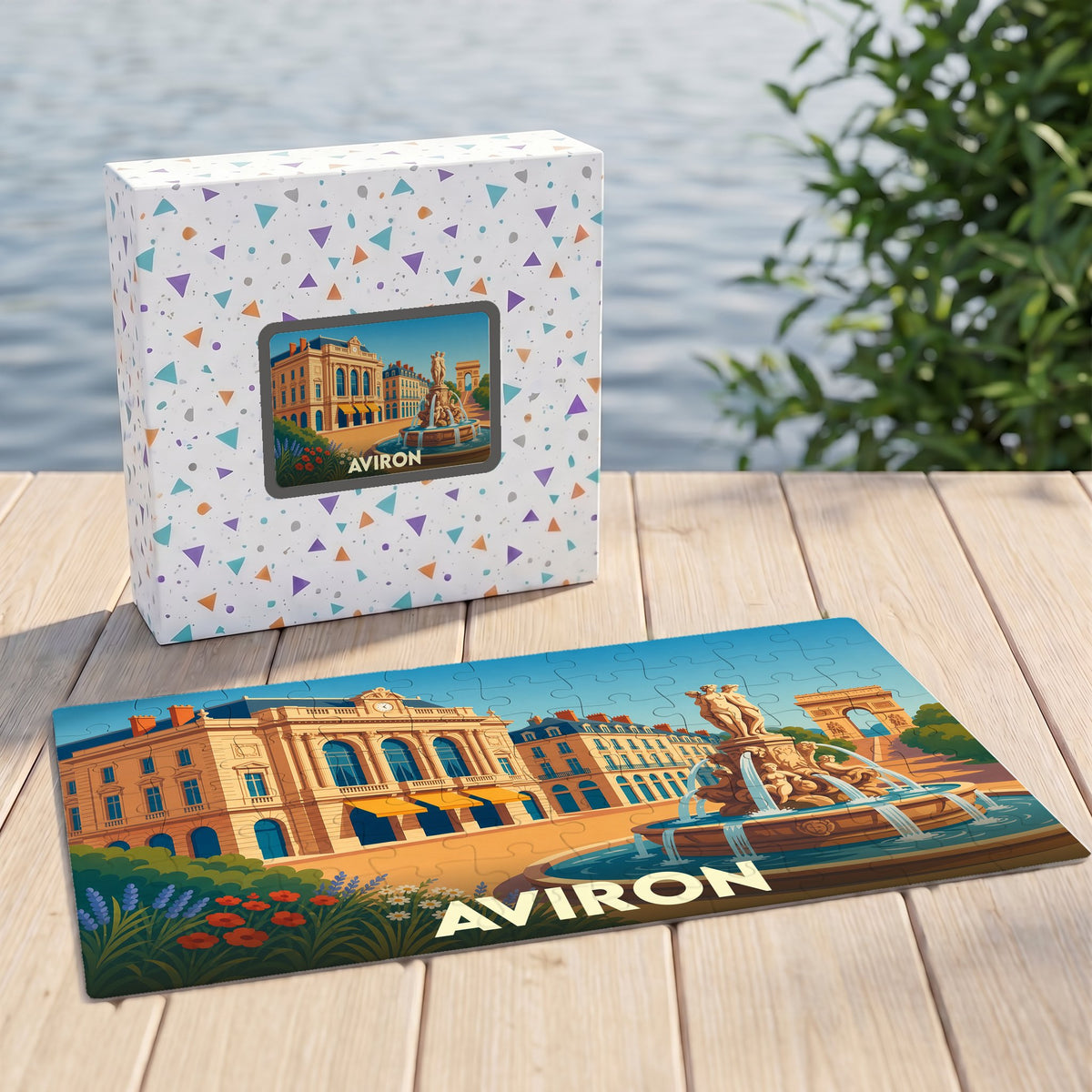 Puzzle souvenir de la ville d'Aviron illustré par une scène urbaine stylisée avec une fontaine et des monuments historiques.