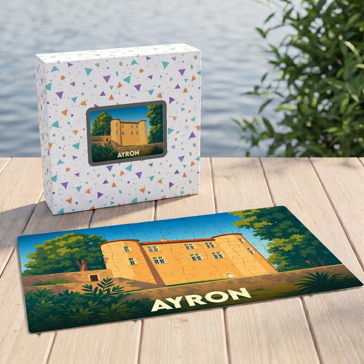 Puzzle souvenir de la ville d'Ayron avec une illustration stylisée d'un château doré.
