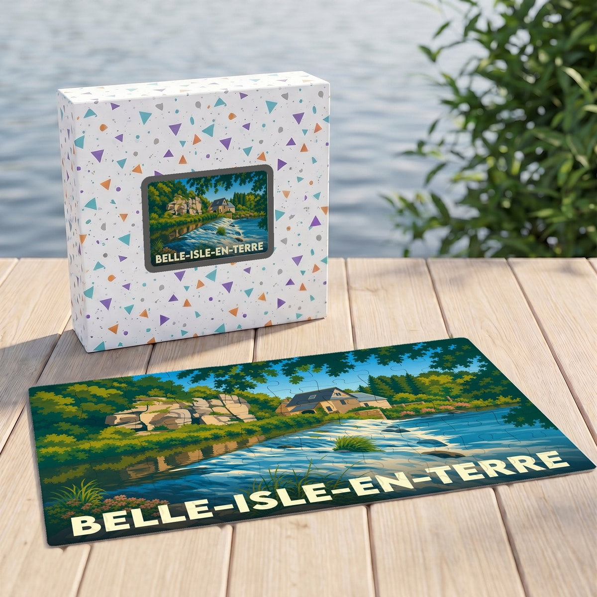 Puzzle souvenir de la ville de Belle-Isle-en-Terre avec son coffret, illustrant un paysage fluvial stylisé.