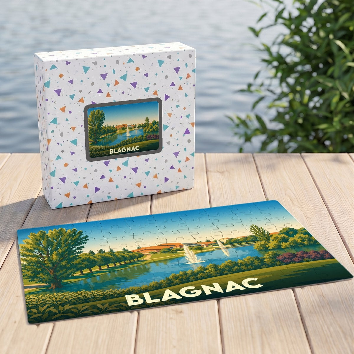 Puzzle souvenir de la ville de Blagnac avec une illustration stylisée d'un parc avec lac et fontaines.