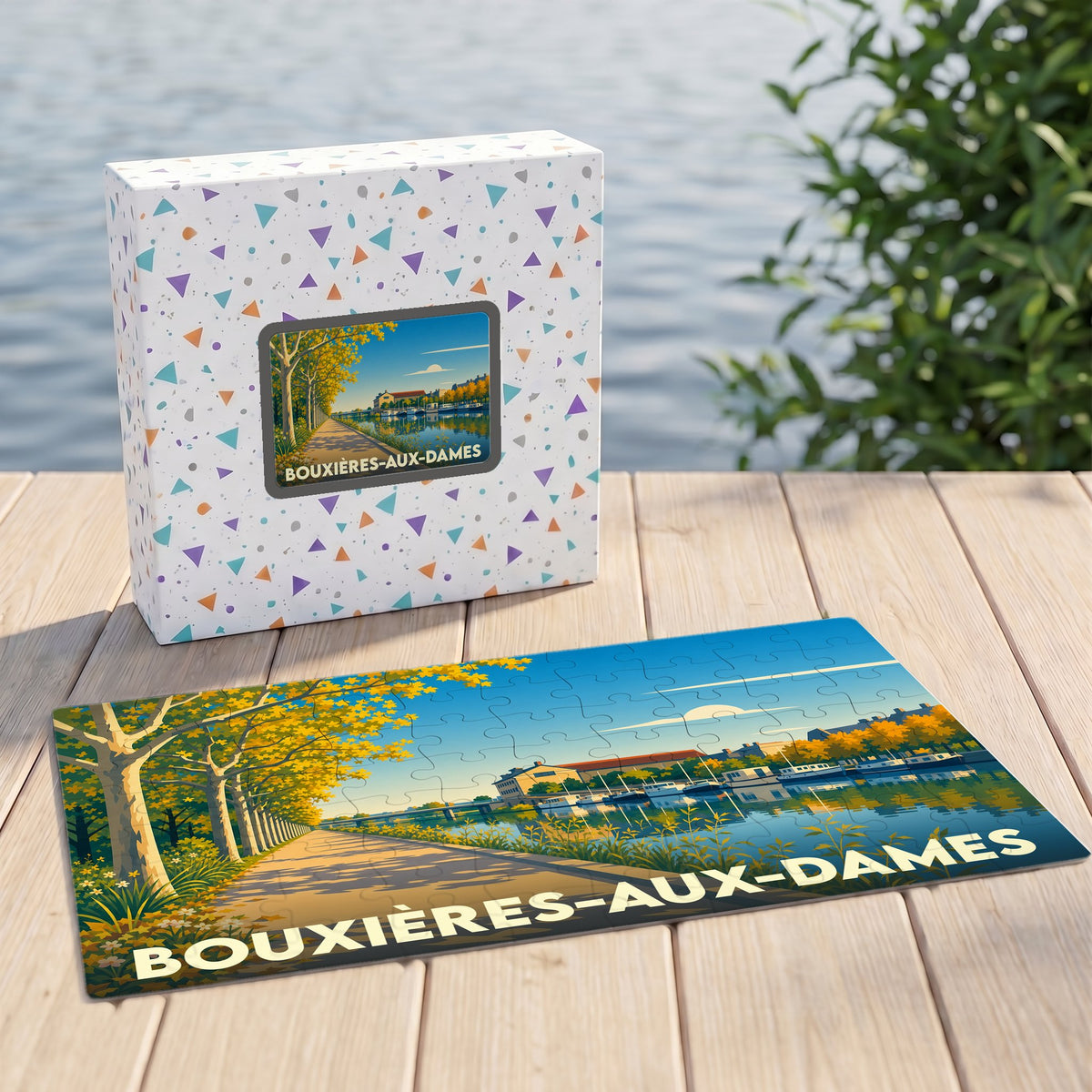 Puzzle souvenir de la ville de Bouxières-aux-Dames avec une illustration stylisée d'un bord de rivière arboré.