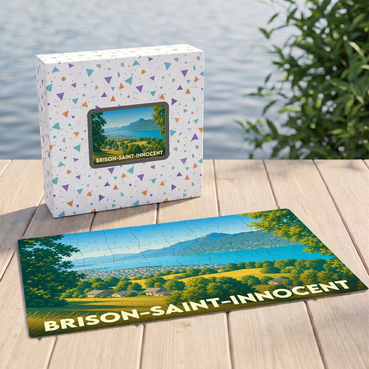Puzzle souvenir de Brison-Saint-Innocent illustrant un paysage lacustre et montagneux dans un style graphique.