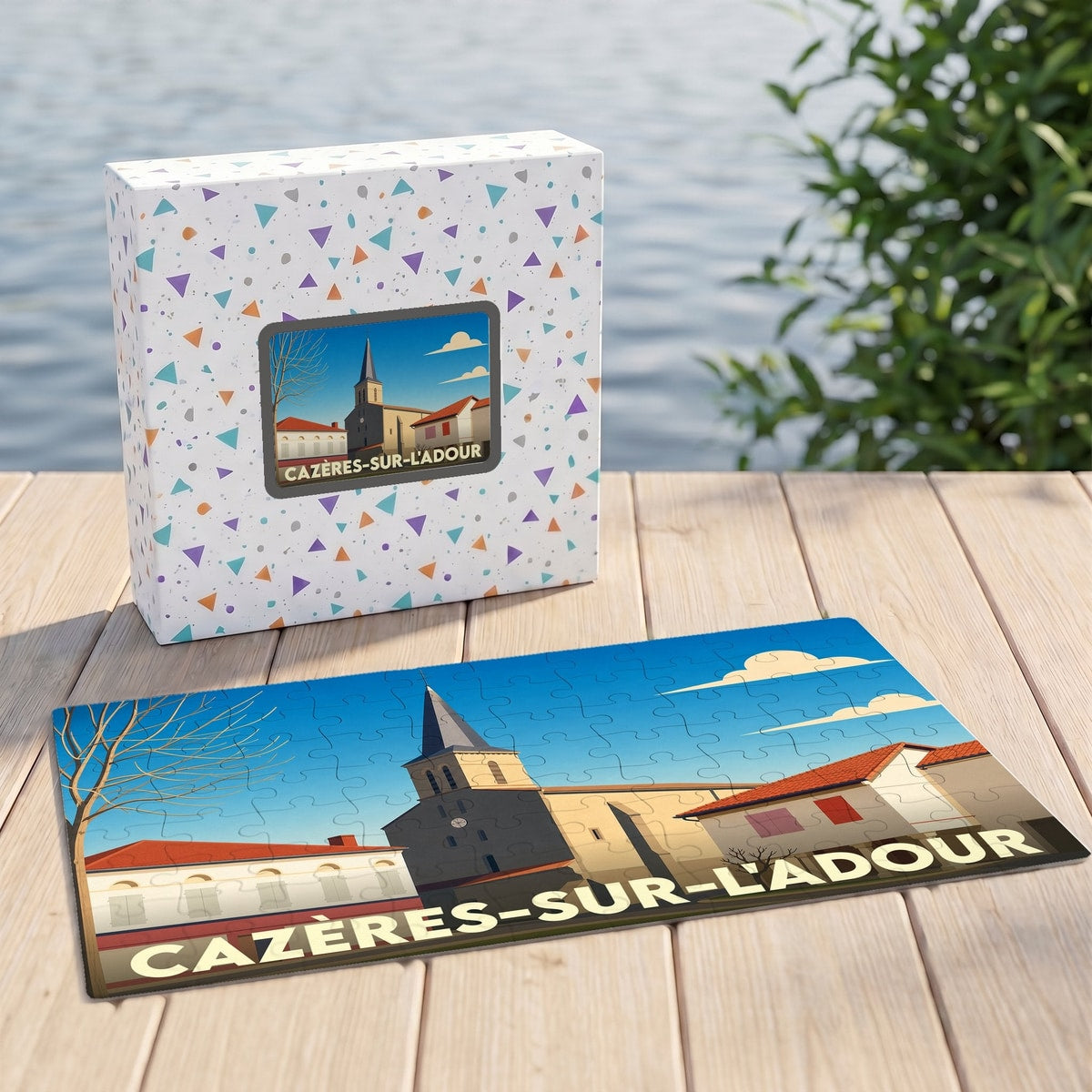 Puzzle souvenir de la ville de Cazères-sur-l'Adour avec une illustration stylisée de son église et de ses maisons.