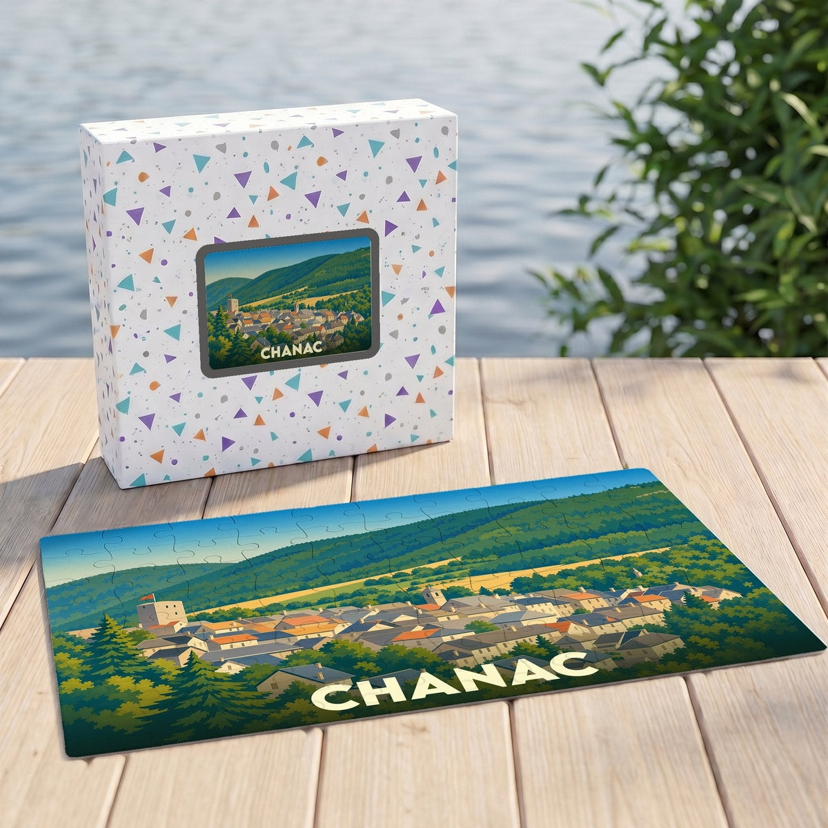 Puzzle souvenir de la ville de Chanac illustrant un paysage de vallée verdoyante et son village typique.