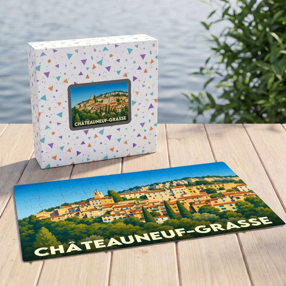 Puzzle souvenir de la ville de Châteauneuf-Grasse avec une illustration stylisée du village et sa boîte assortie.