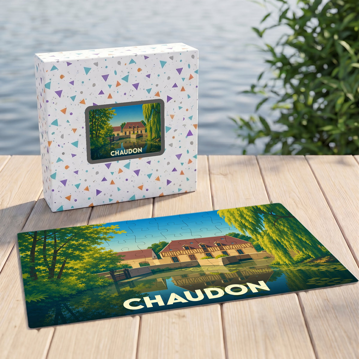Puzzle souvenir de la ville de Chaudon avec une illustration stylisée d'un paysage au bord de l'eau.