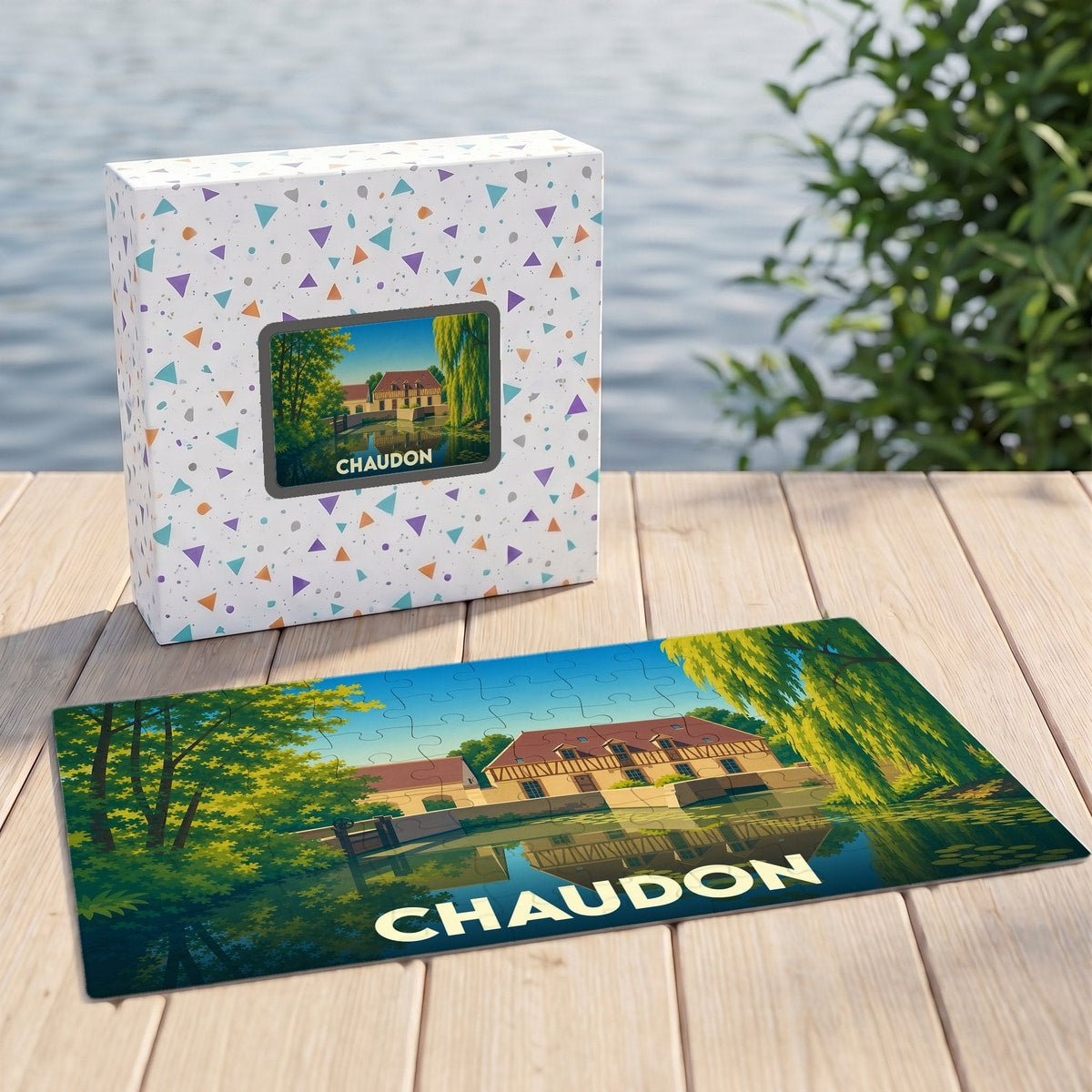Puzzle souvenir de la ville de Chaudon avec une illustration stylisée d'un paysage au bord de l'eau.