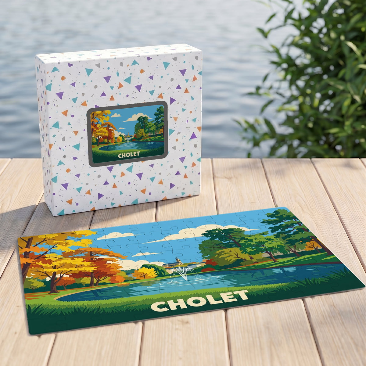 Puzzle souvenir de la ville de Cholet illustrant un parc arboré avec un jet d'eau, présenté avec sa boîte assortie.