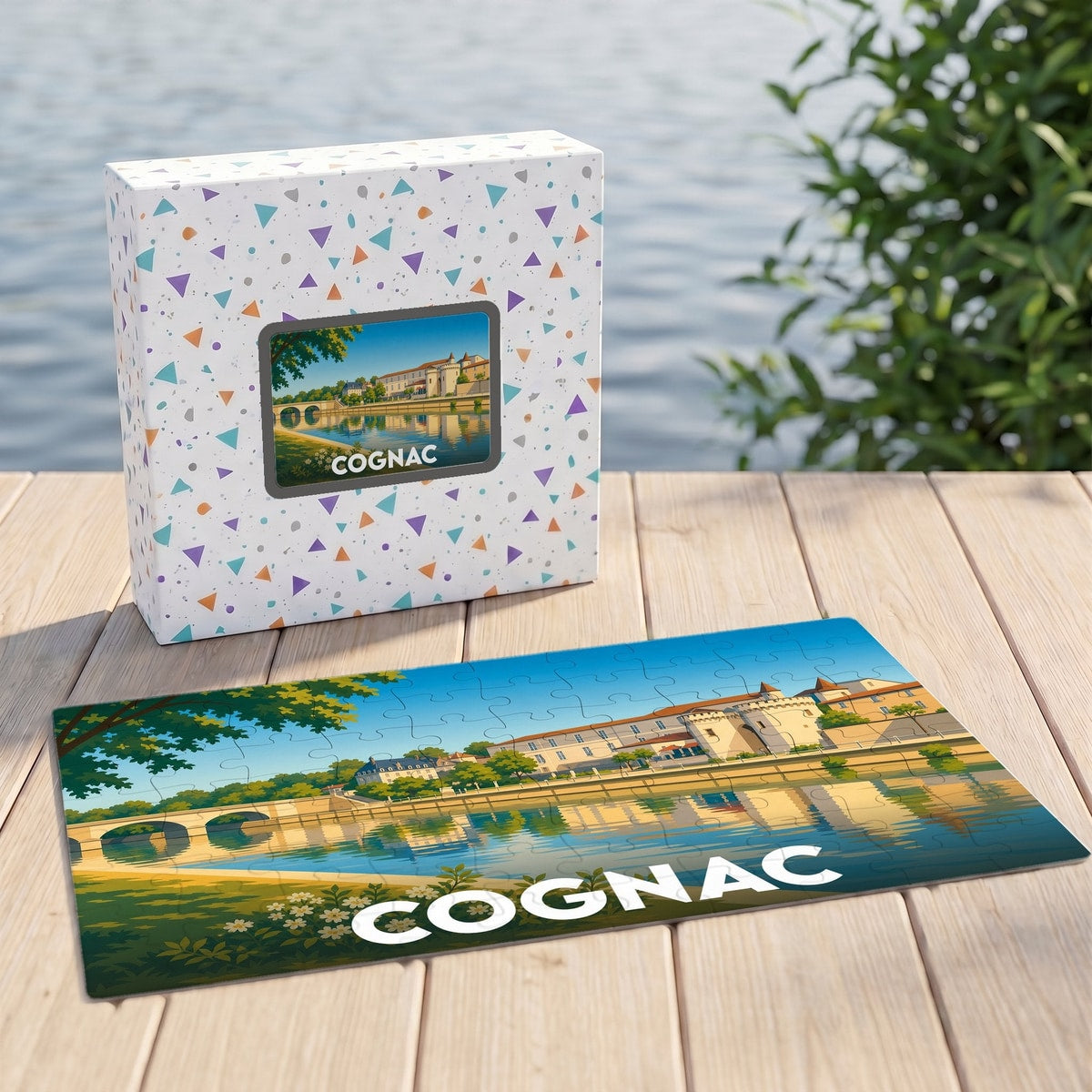 Puzzle souvenir de la ville de Cognac illustré d'un paysage urbain au bord de l'eau.