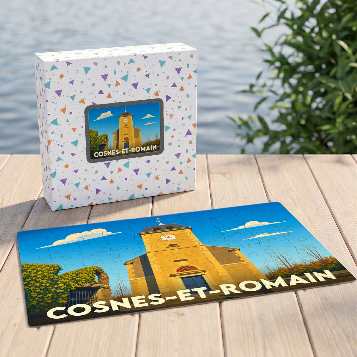 Puzzle souvenir de la ville de Cosnes-et-Romain accompagné de sa boîte, illustrés par un dessin stylisé de l'église locale.