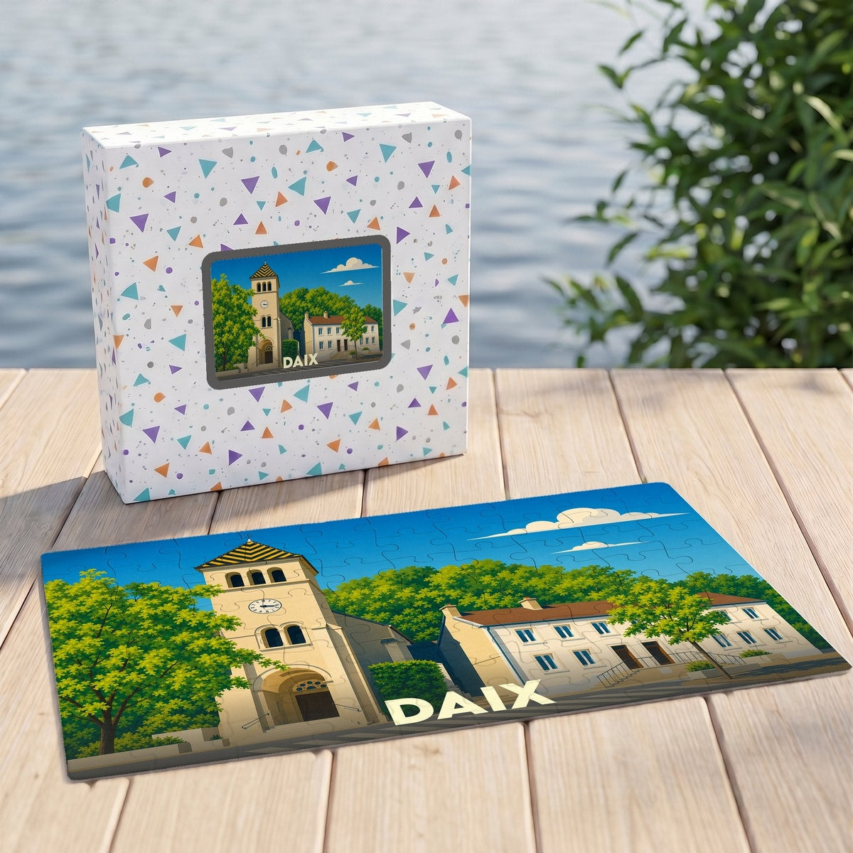 Puzzle souvenir de la ville de Daix illustrant une église et des bâtiments sous un ciel bleu.