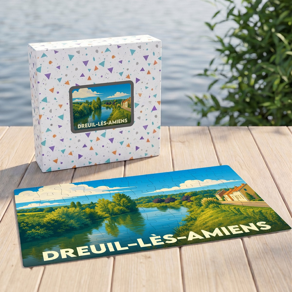 Puzzle souvenir de la ville de Dreuil-lès-Amiens avec une illustration paysagère stylisée.