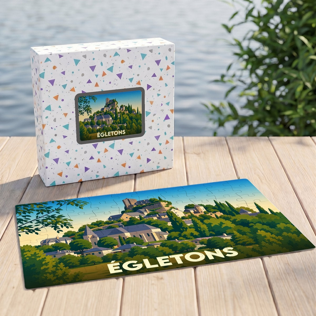 Puzzle souvenir de la ville d'Égletons représentant un paysage illustré avec son château et son église.