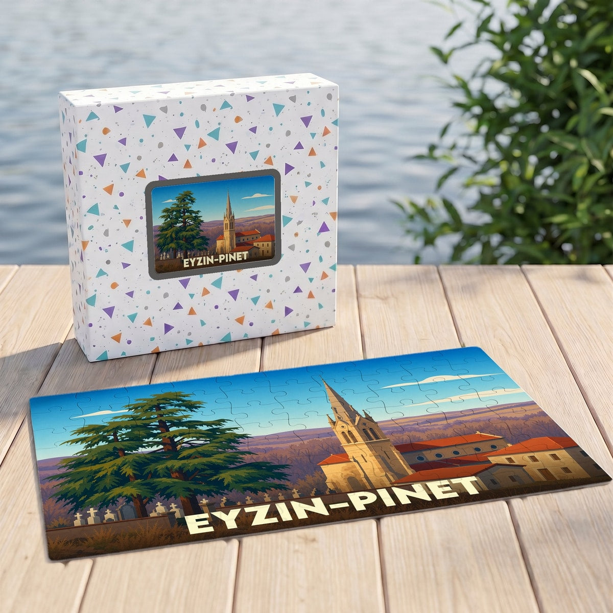 Puzzle souvenir de la ville d'Eyzin-Pinet avec une illustration stylisée de son église et d'un grand cèdre.