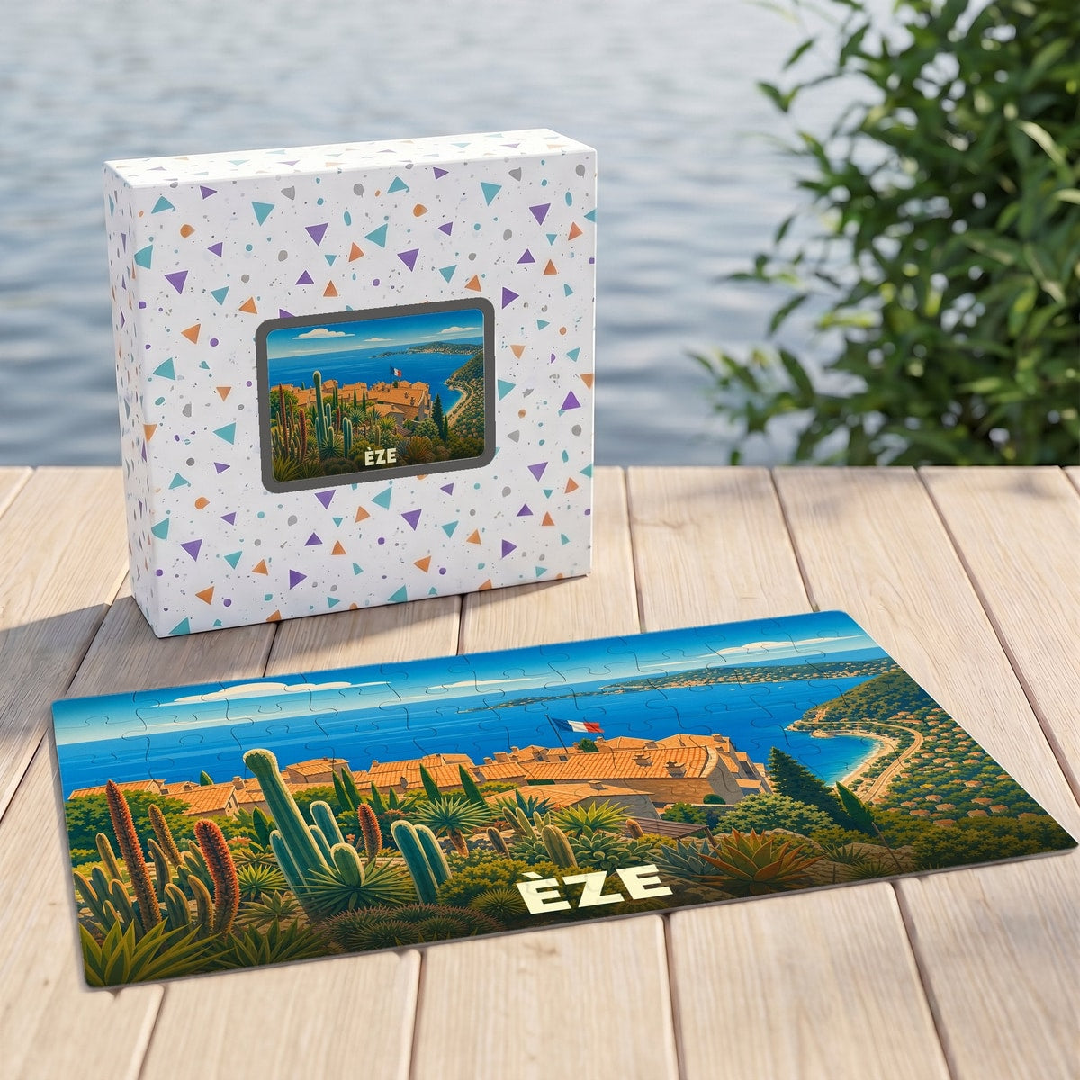 Puzzle souvenir de la ville d'Èze avec une illustration stylisée d'un paysage méditerranéen.