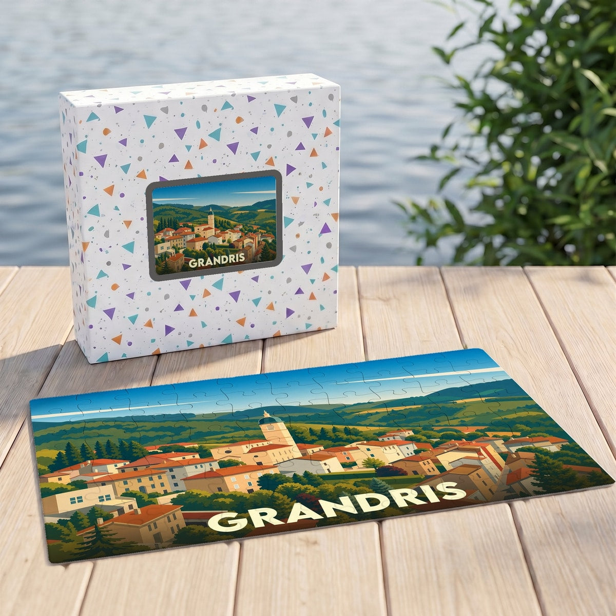 Puzzle souvenir de la ville de Grandris illustrant un paysage de village vallonné, accompagné de sa boîte assortie.