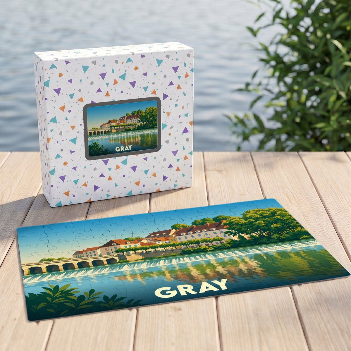 Puzzle souvenir de la ville de Gray avec une illustration stylisée d'un paysage de bord de rivière.