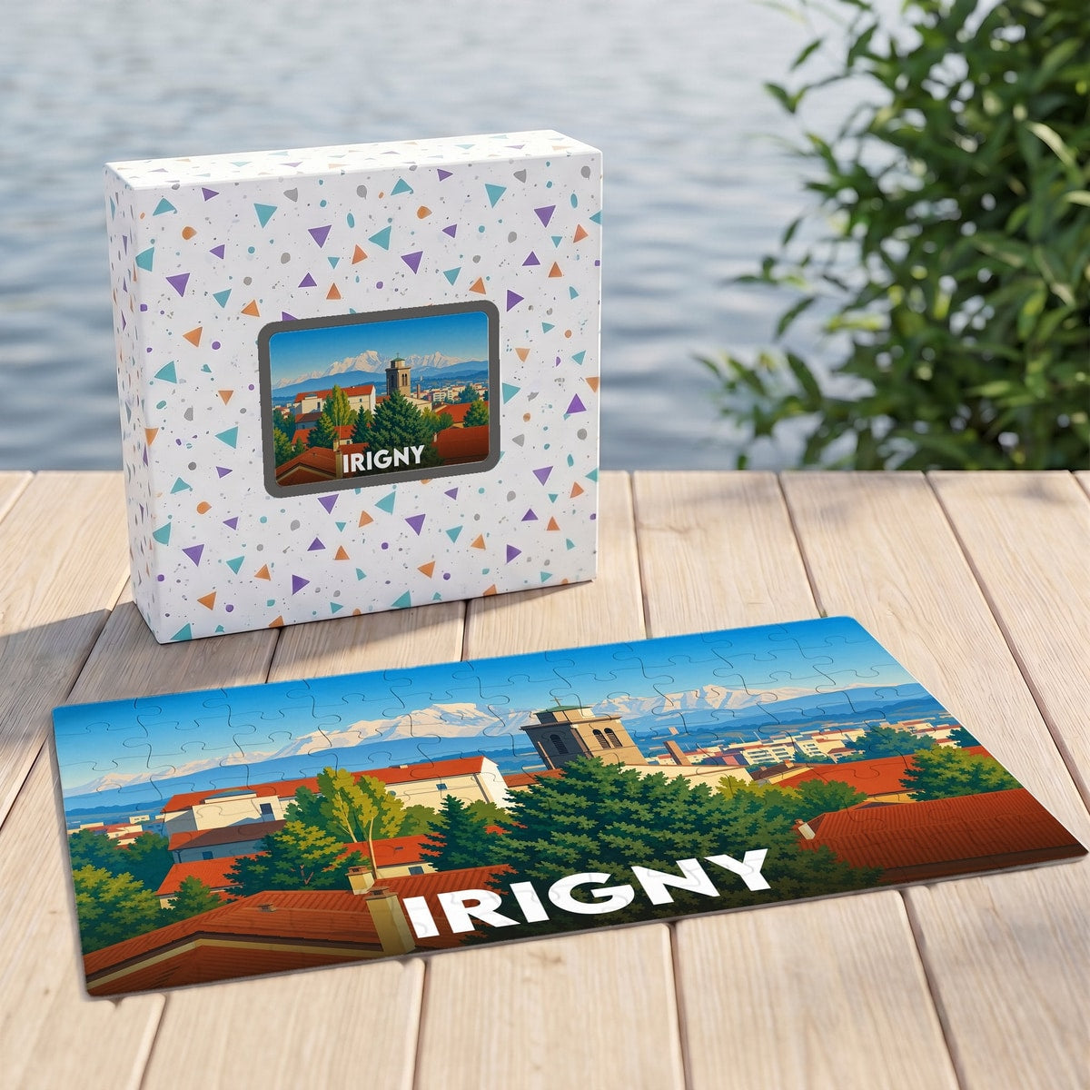 Puzzle souvenir de la ville d'Irigny représentant un paysage urbain illustré devant des montagnes enneigées.
