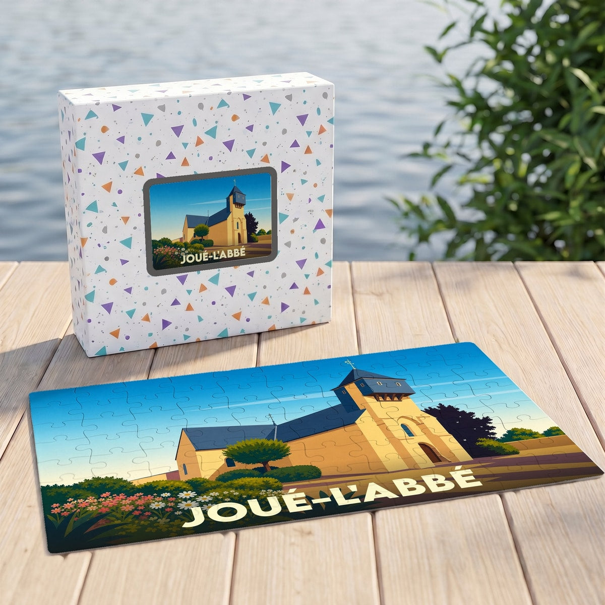 Puzzle souvenir de la ville de Joué-l'Abbé avec une illustration stylisée de son église.