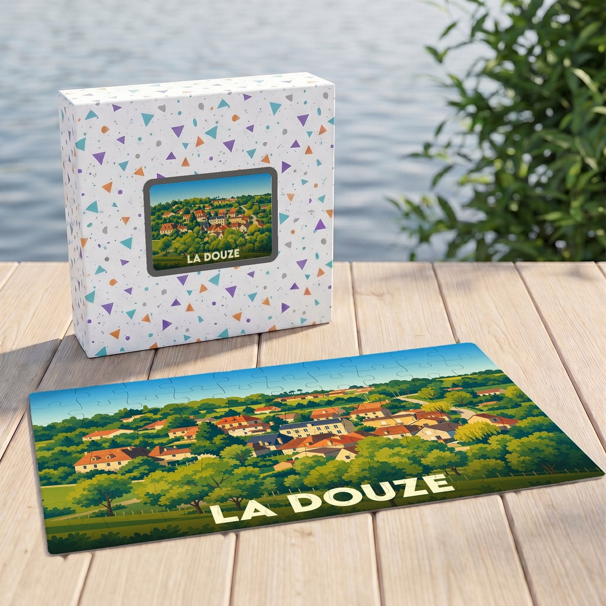 Puzzle souvenir de la ville de La Douze avec une illustration stylisée d'un village vallonné.
