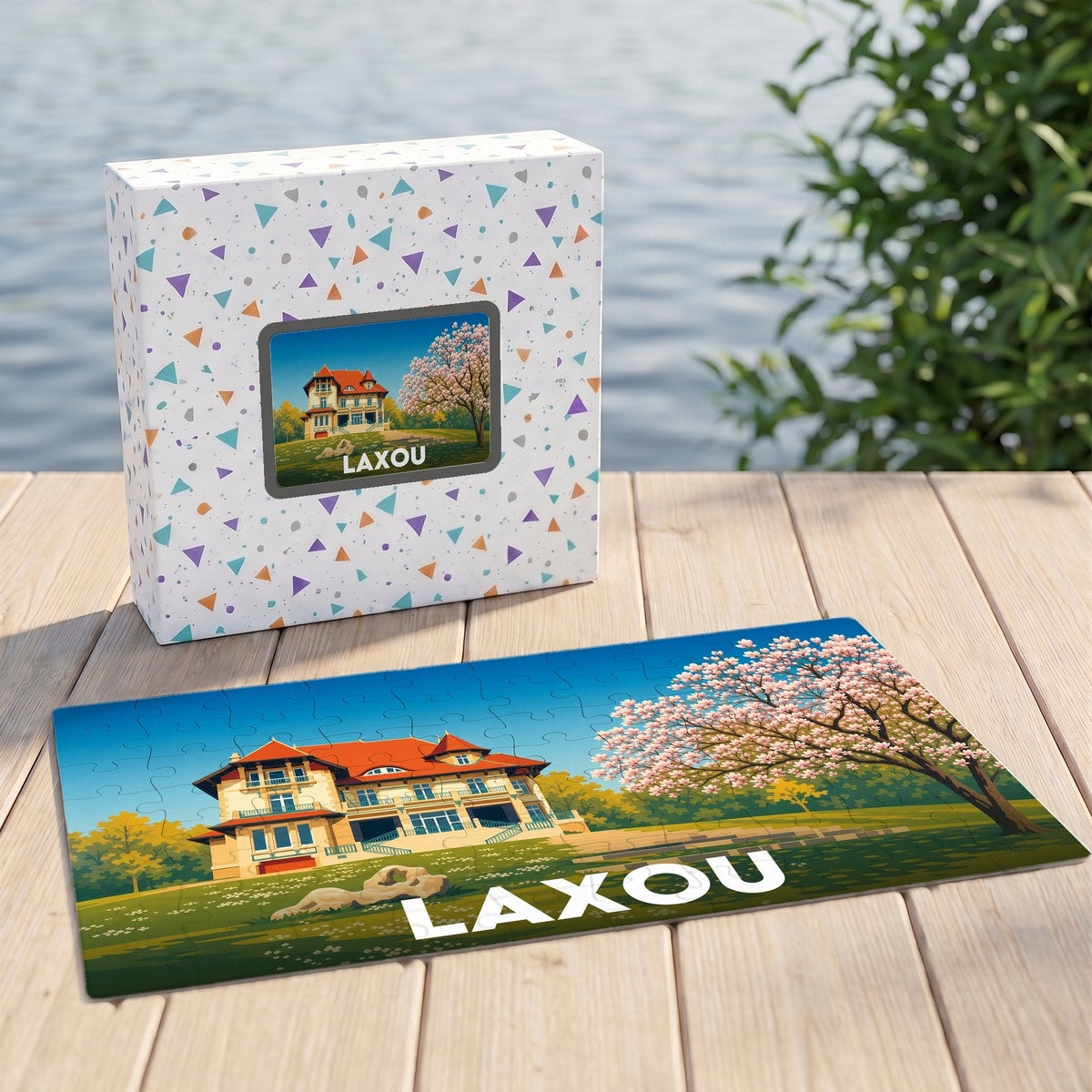 Puzzle souvenir de la ville de Laxou avec une illustration stylisée de villa et de cerisiers.
