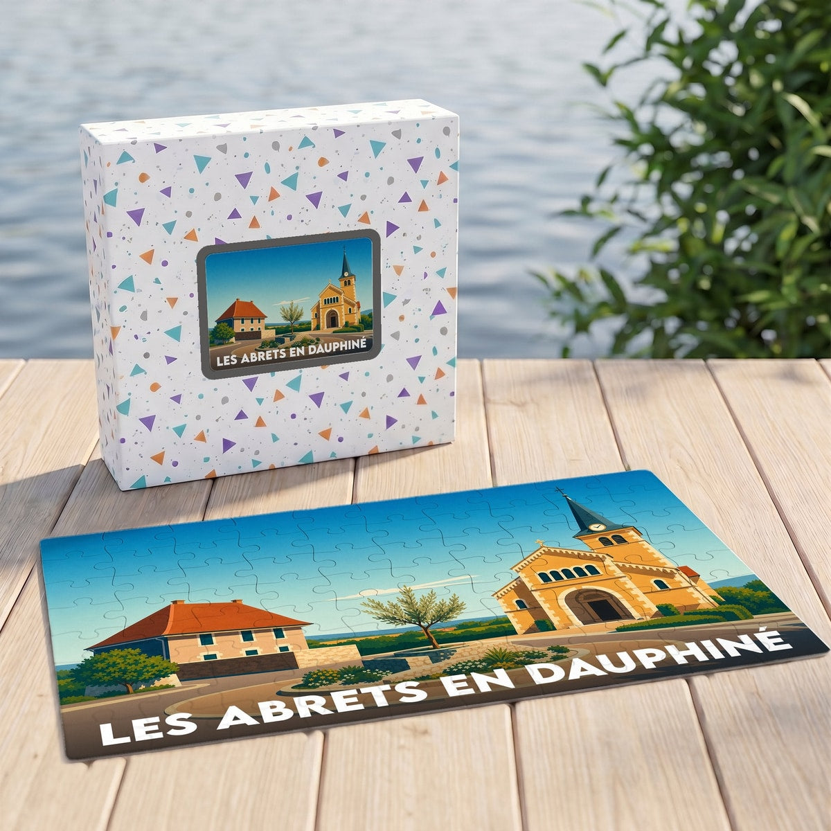 Puzzle souvenir de la ville de Les Abrets en Dauphiné avec son coffret et une illustration stylisée de son église.