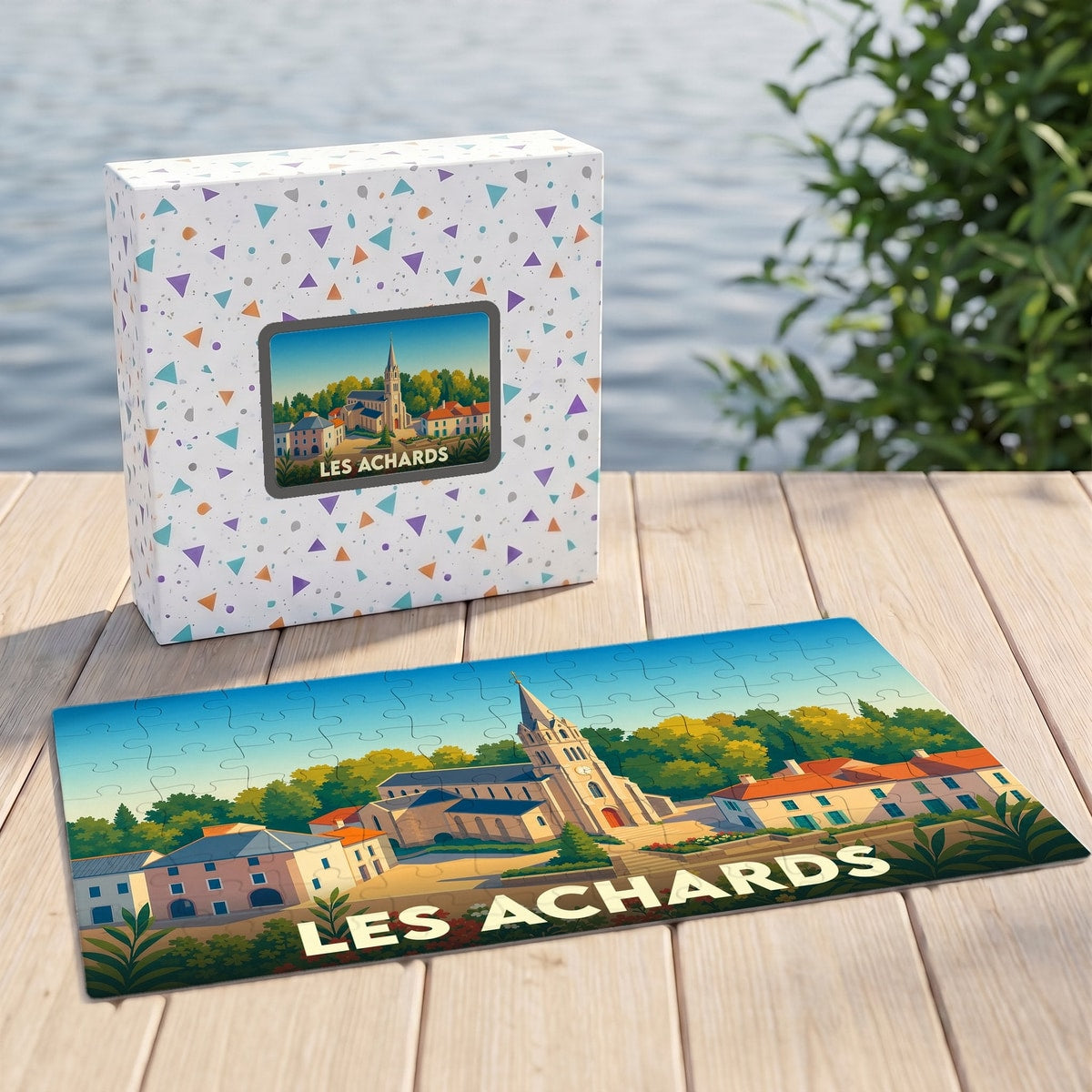 Puzzle souvenir de la ville de Les Achards illustrant une église de style néogothique dans un paysage coloré.