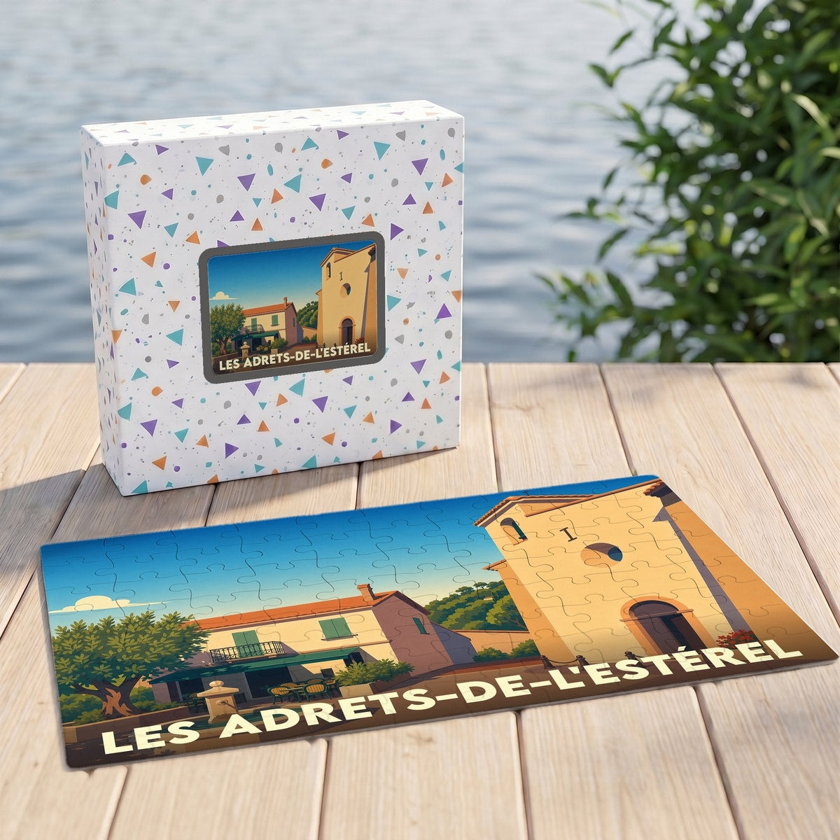 Puzzle souvenir de la ville de Les Adrets-de-l'Estérel avec une illustration stylisée d'un village provençal.