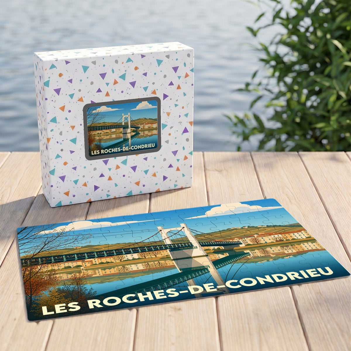 Puzzle souvenir de la ville de Les Roches-de-Condrieu avec une illustration stylisée d'un pont suspendu.