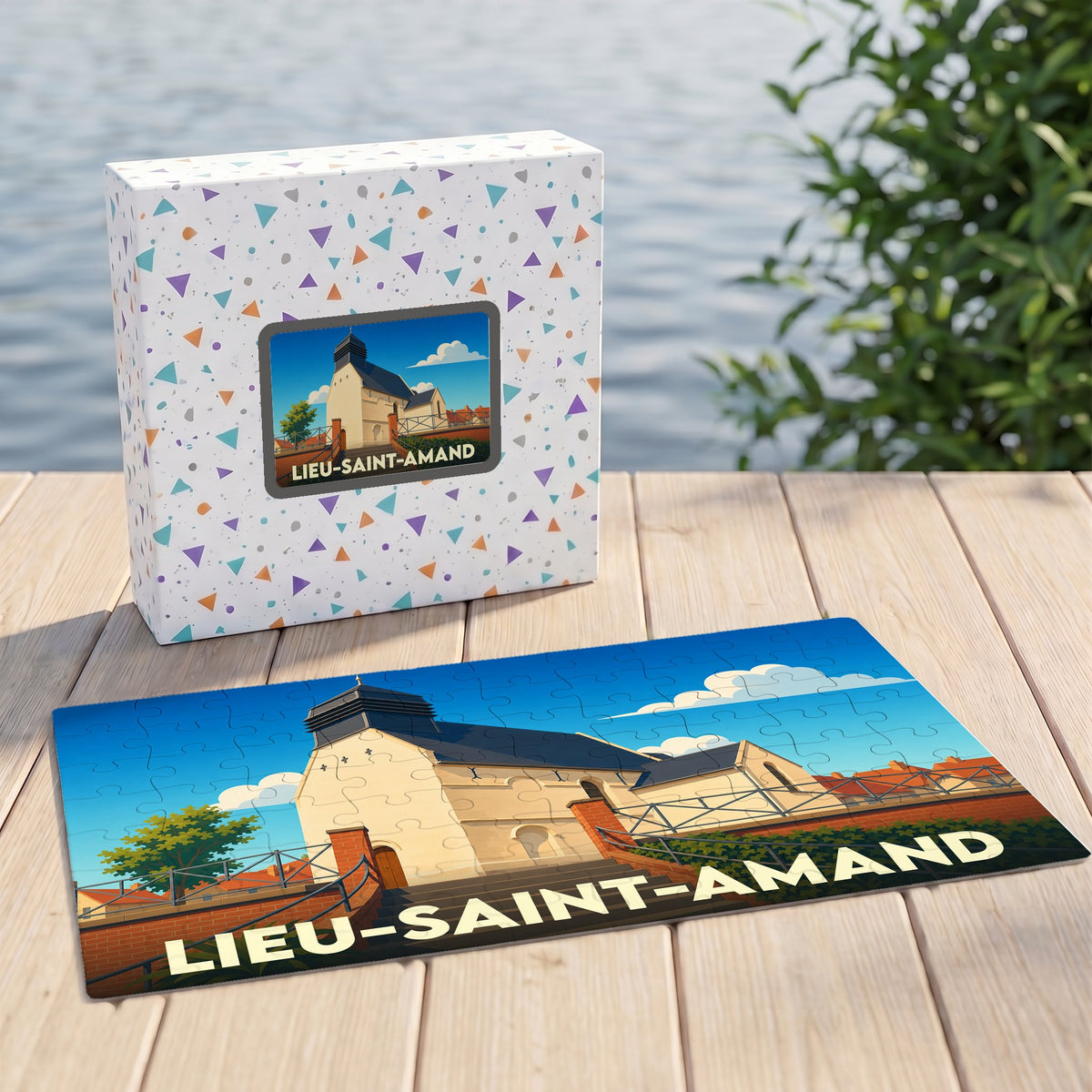 Puzzle souvenir de la ville de Lieu-Saint-Amand avec son emballage et une illustration stylisée de l'église locale.