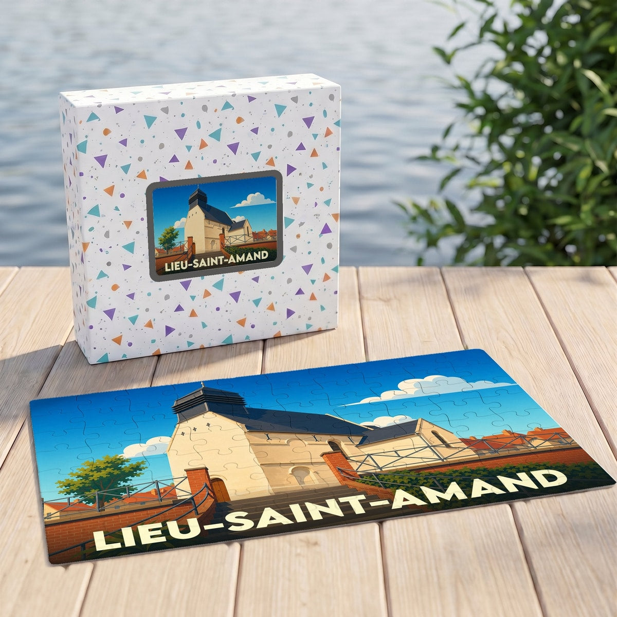 Puzzle souvenir de la ville de Lieu-Saint-Amand avec son emballage et une illustration stylisée de l'église locale.