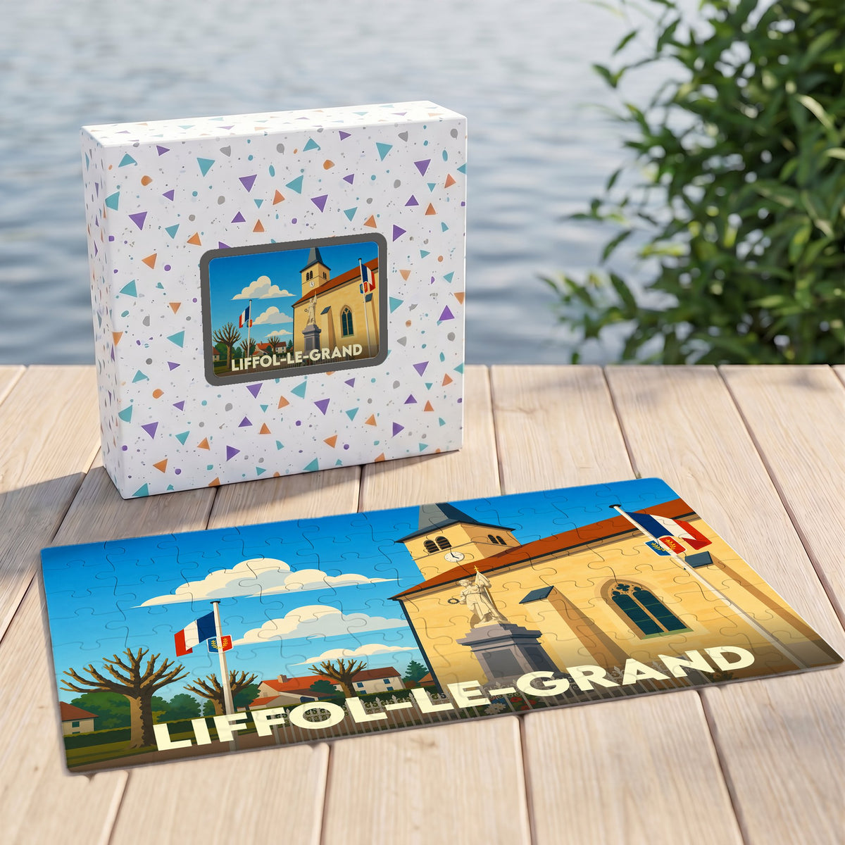 Puzzle souvenir de la ville de Liffol-le-Grand avec une illustration stylisée de son église et de drapeaux français.