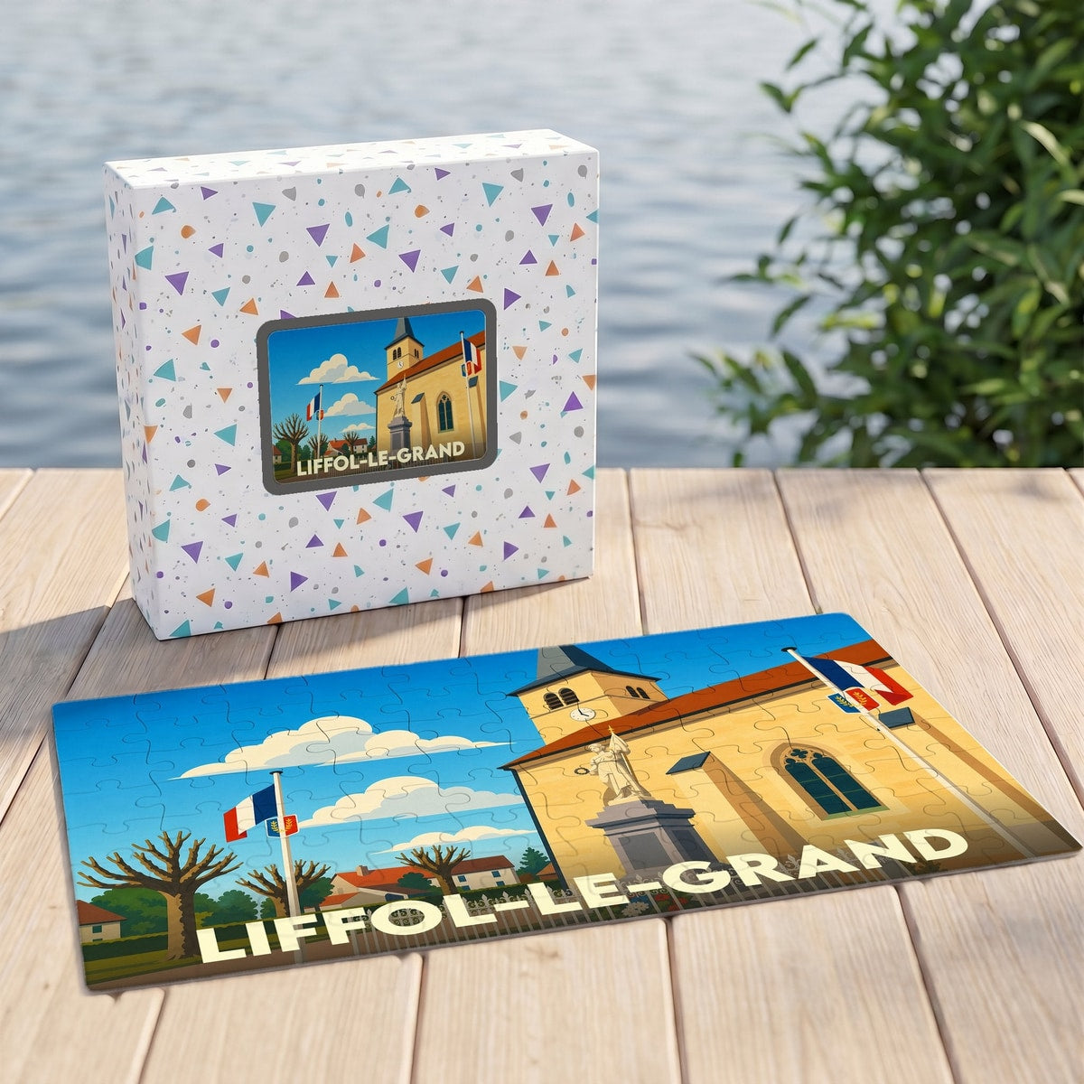 Puzzle souvenir de la ville de Liffol-le-Grand avec une illustration stylisée de son église et de drapeaux français.