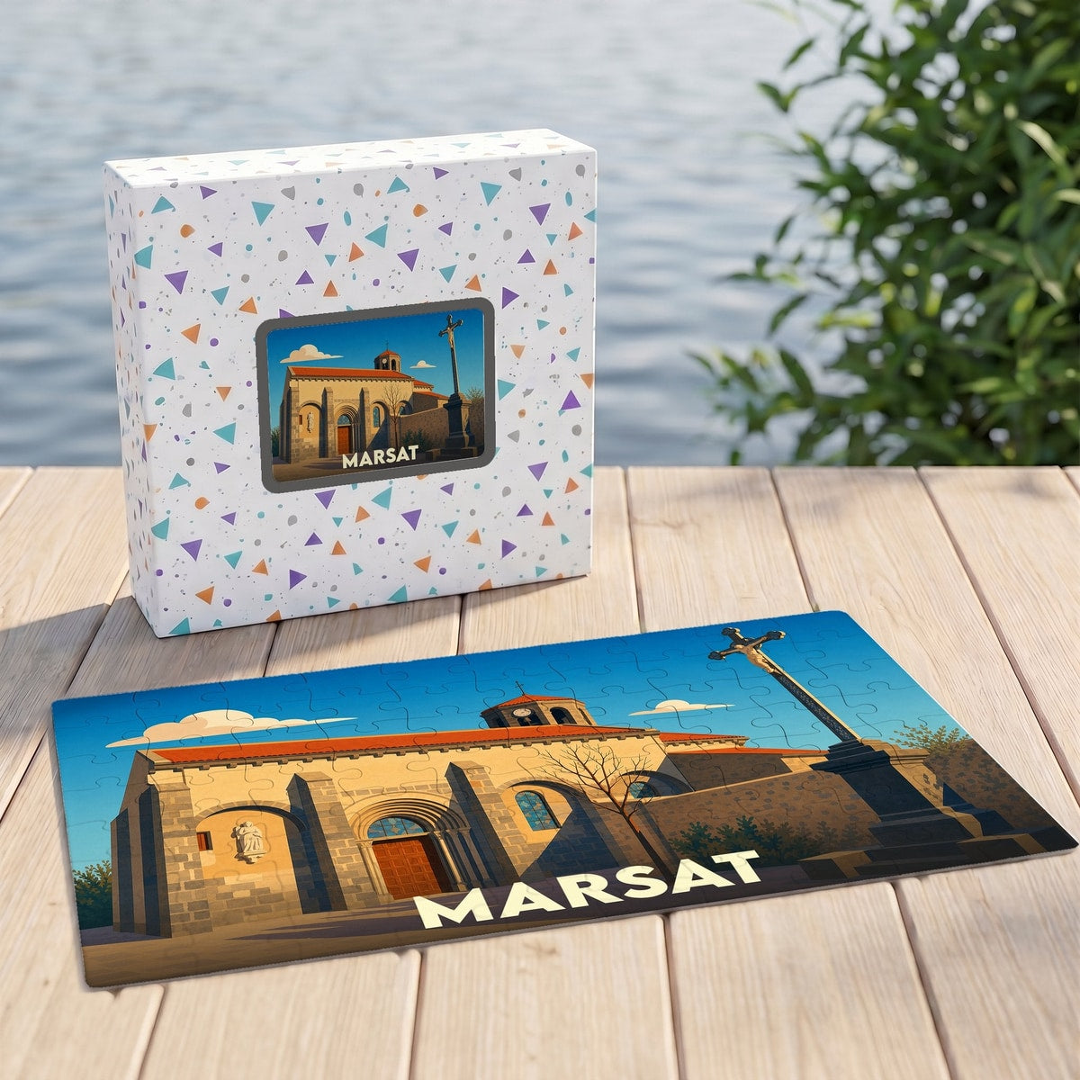 Puzzle souvenir de la ville de Marsat avec une illustration stylisée de son église et d'un calvaire.