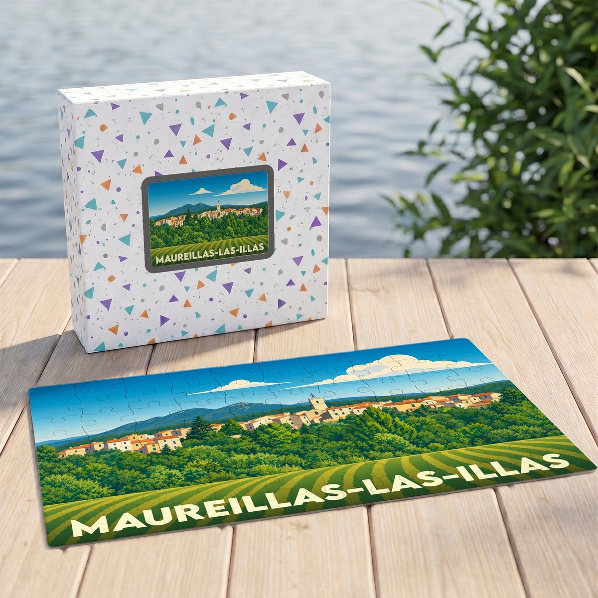 Puzzle souvenir de la ville de Maureillas-las-Illas avec une illustration stylisée d'un paysage de village.