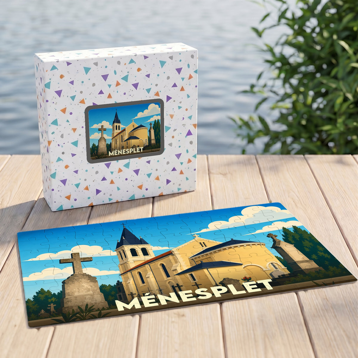 Puzzle souvenir de la ville de Ménesplet avec une illustration stylisée d'une église et de son cimetière.